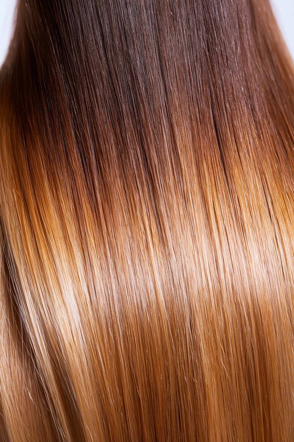 MOFRA Ombré clip-in hair extensions texture close-up, straight strands dark roots to blonde